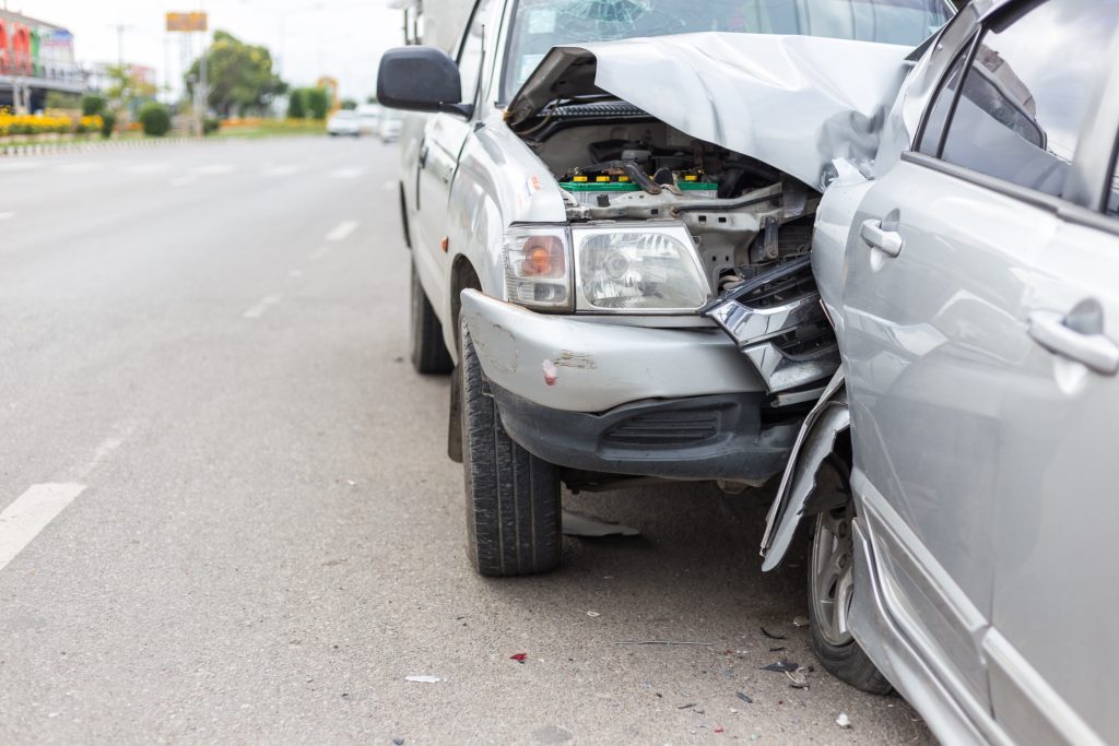 A rear-end collision between two grey cars.