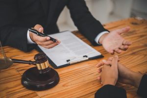 a solicitor discussing with their client a broken ankle at work claim. 