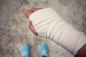 A close up of an injured person's bandaged right hand