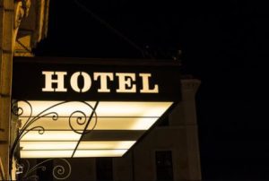 An illuminated sign at the front of a hotel building