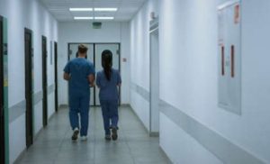 Two hospital staff members walking through a hallway