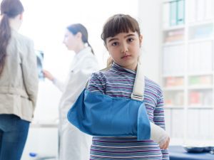Child with her arm in a medical sling