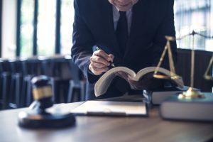 A solicitor researching farming accident claims at a table. 