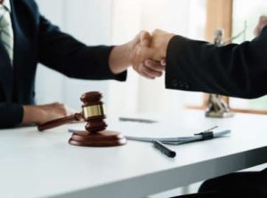 A criminal injury compensation solicitor and a client shaking hands
