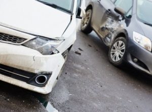 Two cars both with damage on one side following a collision