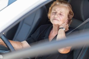 A woman suffers from whiplash in her car. She may have a whiplash compensation claim.