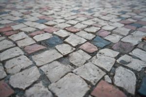 A closeup view of a pavement with cobblestone tiles