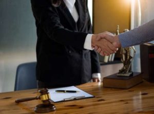 A personal injury solicitor and a client shaking hands on an agreement