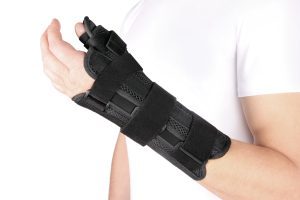 A man wearing a hand support after sustaining a broken wrist at work