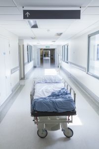 EMPTY HOSPITAL GURNEY IN CORRIDOR INDICATING CARE HOME NEGLIGENCE DEATH CLAIMS