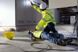 A COLLEAGUE SHOWN RAISING ALARM FOR AN INJURED EMPLOYEE