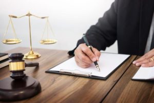 A personal injury solicitor filling out a form while sat at a desk