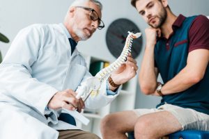 PERSON CONSULTING WITH SPINAL DOCTOR AND CONSIDERING SPINAL INJURY COMPENSATION CLAIM