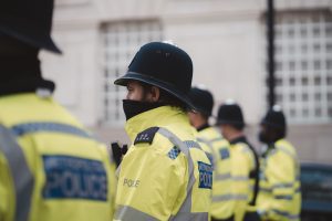 Police officers in yellow hi-vis clothing wearing helmets. 