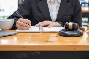 A solicitor works on an NHS walk in centre medical negligence claim a desk.