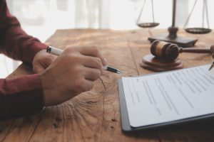 A solicitor works on a successful injury claim at his desk.