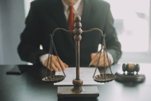 a solicitor sitting at his desk completing paperwork 