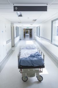 EMPTY HOSPITAL BED IN A CORRIDOR