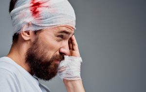 person with bleeding head and ear damage