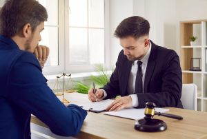 A lawyer show a client how to use compensation tables for personal injury.