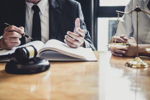 Two personal injury solicitors sit at a desk.