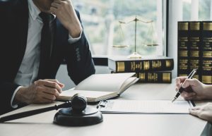 A solicitor and claimant signing paperwork to work on a cervical cancer misdiagnosis claim. 