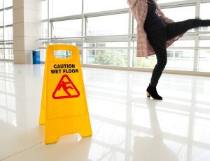 PERSON SLIPPING ON A WET FLOOR IN A PUBLIC PLACE.