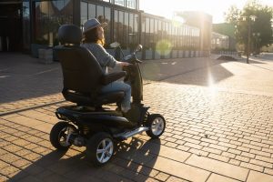 Woman riding a mobility scooter after suffering from serious injuries in an accident 