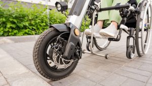 Woman riding a three wheel mobility scooter after suffering serious spine injury in a car accident 